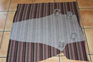 One cut pattern piece upside down on top of the remaining un-cut fabric